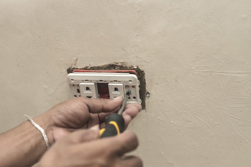 Handyman repairing electrical outlet